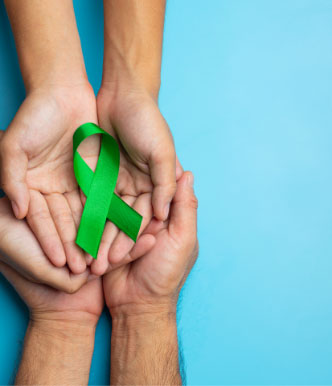 world-mental-health-day-green-ribbon-put-human-s-hands-holding-green-ribbon-blue-background, it does not mean failure, how therapy sets you up for success