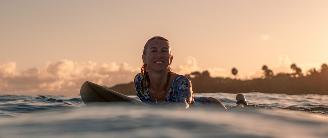 woman on surfboard in the ocean at dusk, depression and anxiety, two very close friends