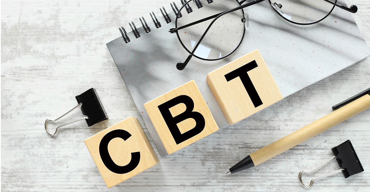 CBT-spelled-out-in-scrabble-letters-with-glasses-a-notepad-a-pen-and-two-big-paper-clips-on-a-white-wood-background-does-cognitive-behavioral-therapy-work-iMind-Mental-Health-Solutions