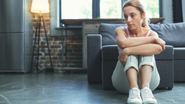 woman-sitting-on-the-floor-with-arms-crossed-and-looking-down-when-you-dont-want-the-divorce-iMind-Mental-Health-Solutions