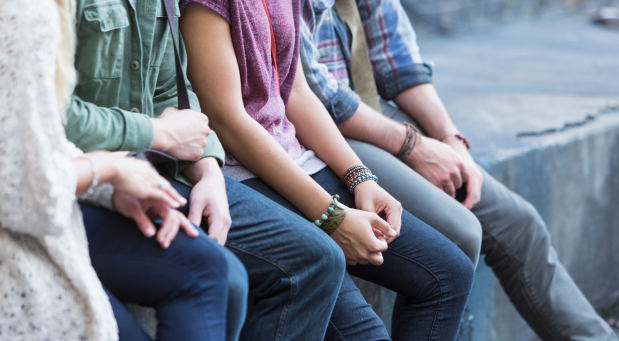 a-group-of-young-adults-sitting-on-a-ledge-why-is-everybody-depressed-iMind-Mental-Health-Solutions-