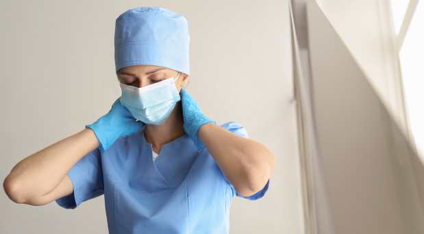 stressed-healthcare-worker-with-hands-around-neck-and-a-mask-on-why-is-everybody-depressed-iMind-Mental-Health-Solutions