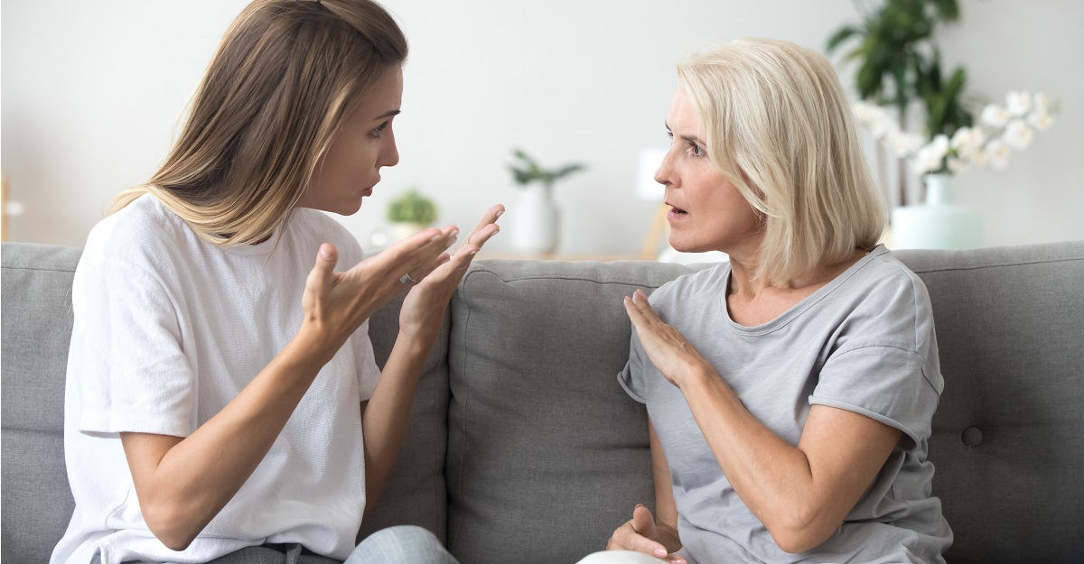 Mother-in-law-arguing-with-daughter-in-law-while-they-both-sit-on-a-couch-toxic-behavior-examples-iMind-Mental-Health-Solutions.