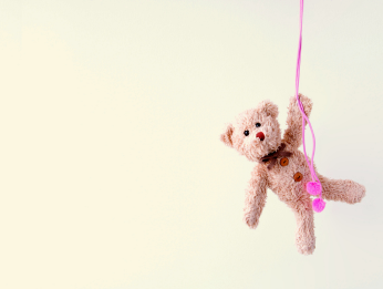 Teddy-bear-hanging-onto-a-pink-ribbon-childhood-neglect-and-mental-health-iMind-Mental-Health-Solutions
