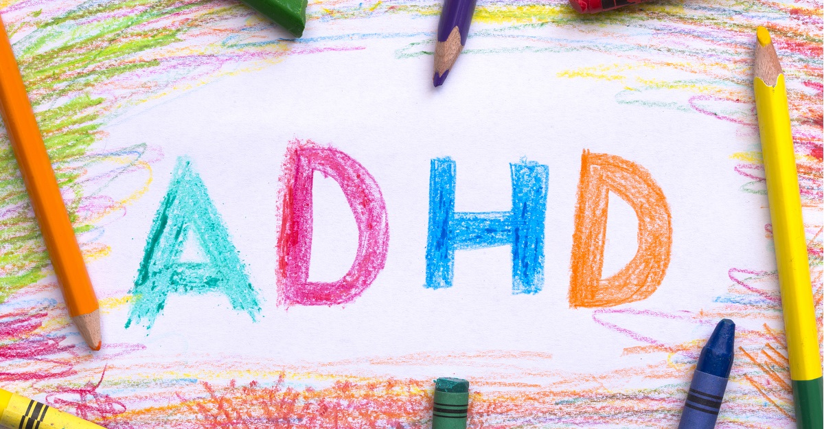 The-letters-ADHD-written-in-crayon-on-a-piece-of-paper-with-crayons-and-pencils-around-it-does-your-child-have-ADHD-iMind-Mental-Health-Solutions