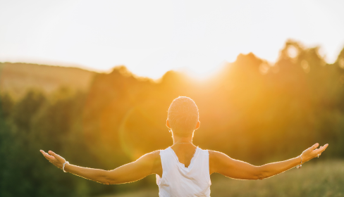 person-with-arms-outstretched-looking-toward-the-sun-setting-on-a-forest-what-is-limerence-iMind-Mental-Health-Solutions
