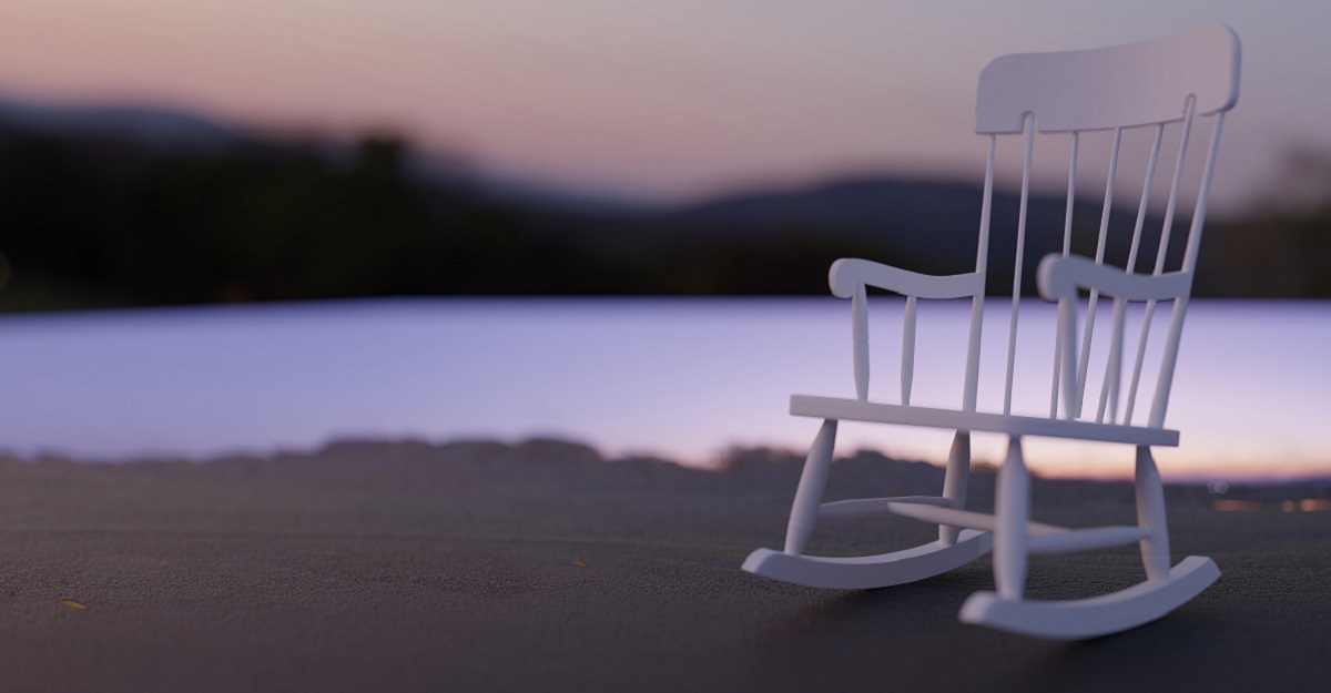 empty-rocking-chair-facing-the-camera-with-sunset-over-a-lake-witih-tress-on-other-side-of-it-first-Mothers-Day-after-losing-your-Mom-iMind-Mental-Health-Solutions.