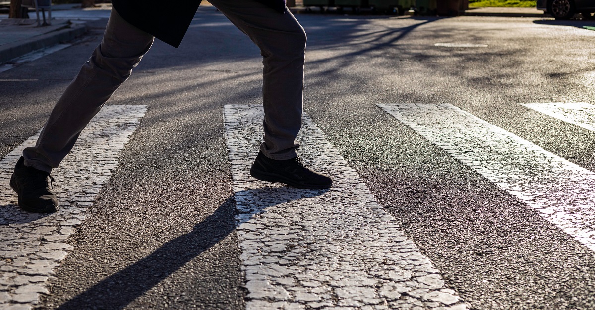 man-in-black-pants-and-shoes-trying-not-to-step-between-the-lines-on-a-crosswalk-concept-of-OCD-inside-the-life-of-someone-with-OCD-iMind-Mental-Health-Solutions.