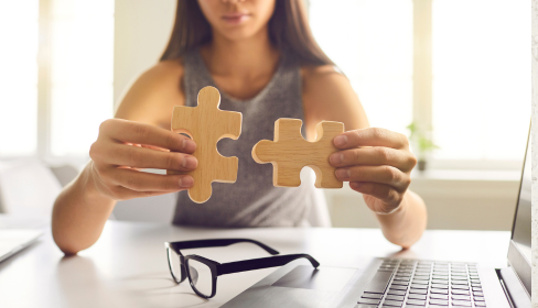 woman-holding-two-pieces-of-a-wooden-puzzle-that-fit-together-what-is-catastrophizing-and-how-to-stop-it-iMind-Mental-Health-Solutions